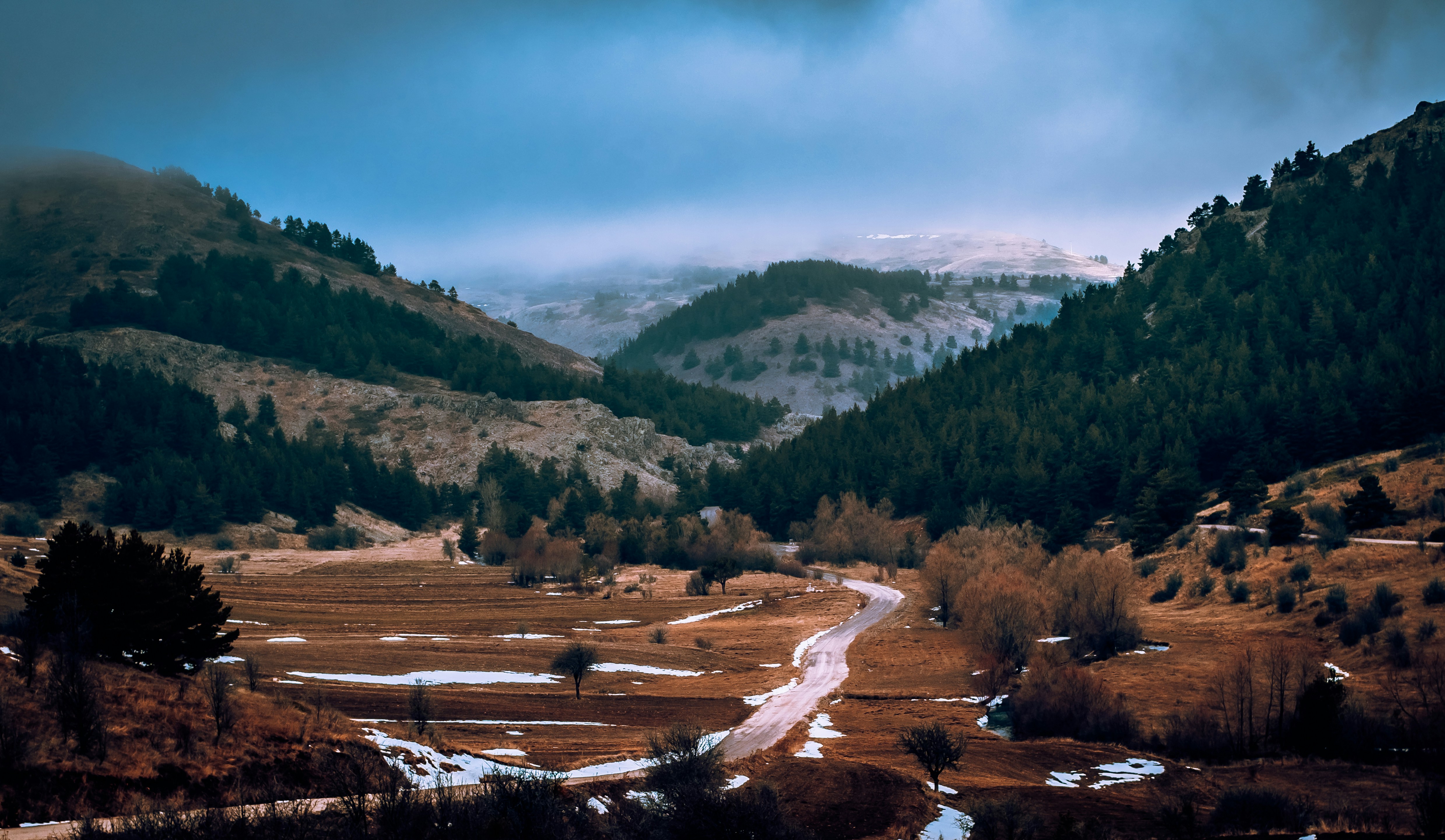 a road in the middle of a mountain valley