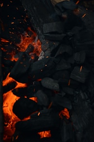 a pile of wood sitting next to a fire
