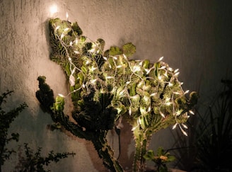 Warmly lit holiday lights woven among rustic desert plants at sunset, invoking the Southwest spirit.