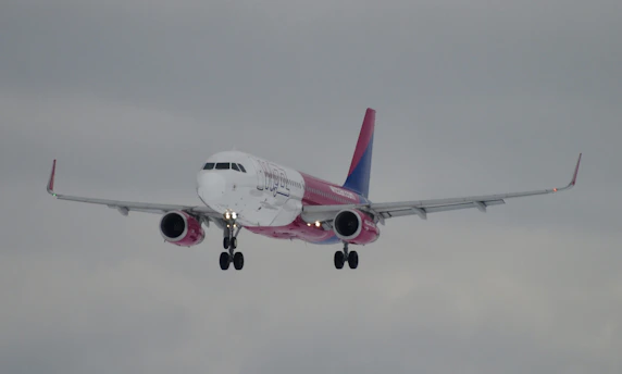 a large jetliner flying through a cloudy sky