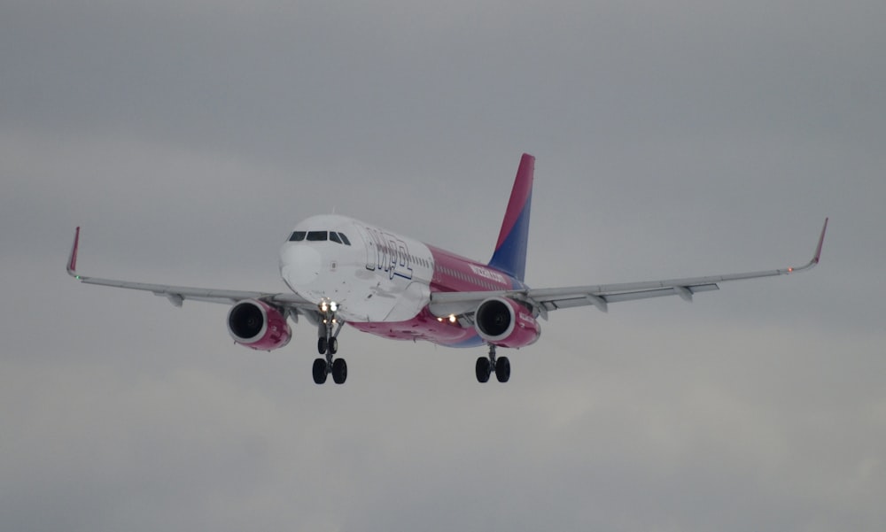 a large jetliner flying through a cloudy sky