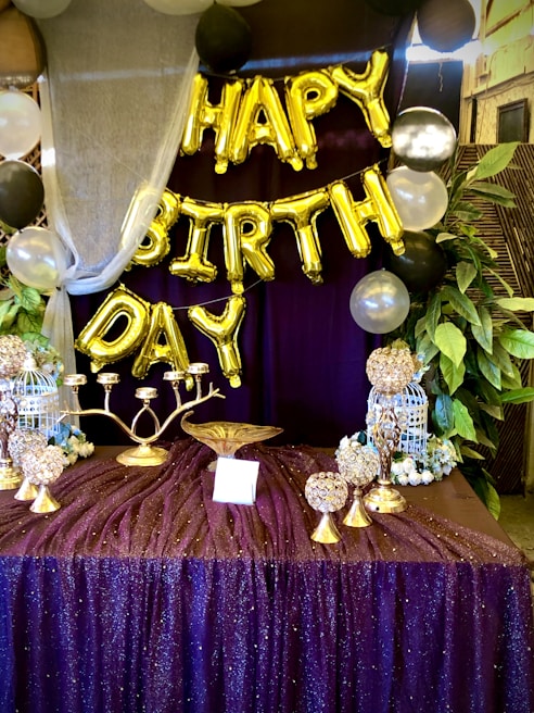 An elegant birthday party setup featuring balloons and table decor.