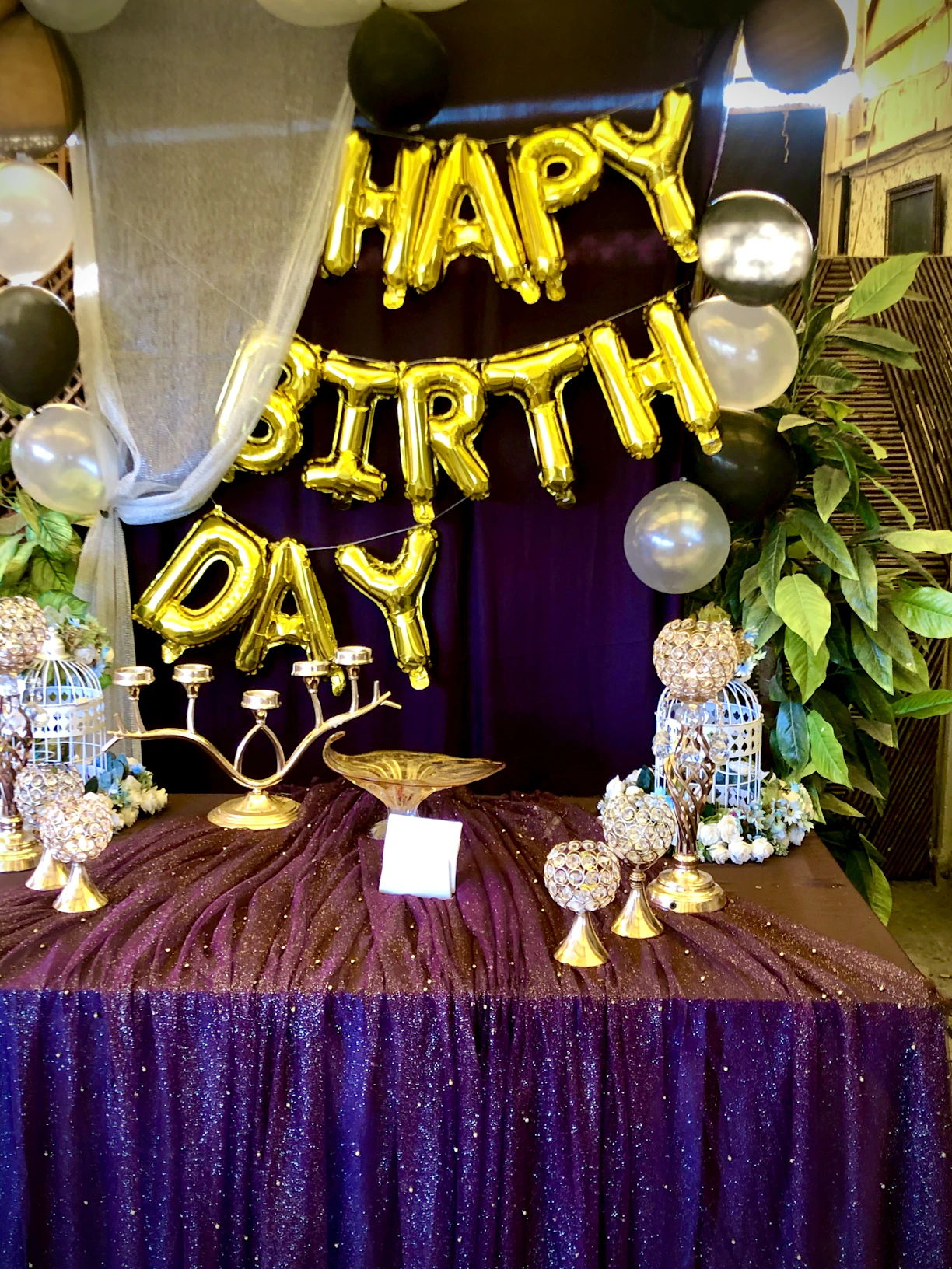 Close-up of a beautifully decorated birthday table with colorful balloons and themed party props.