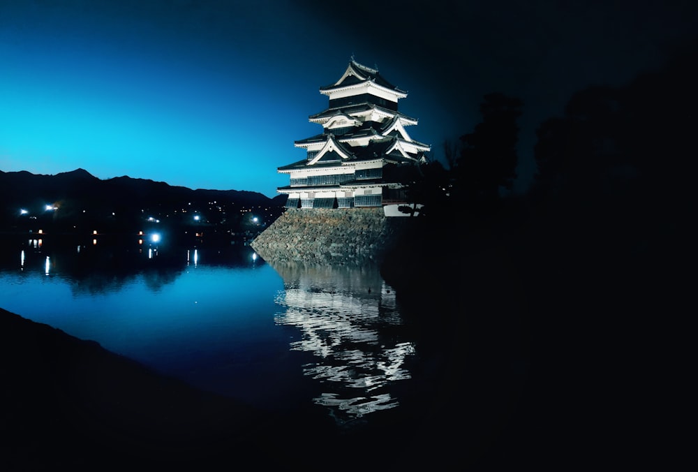 a tall white building sitting on top of a lake