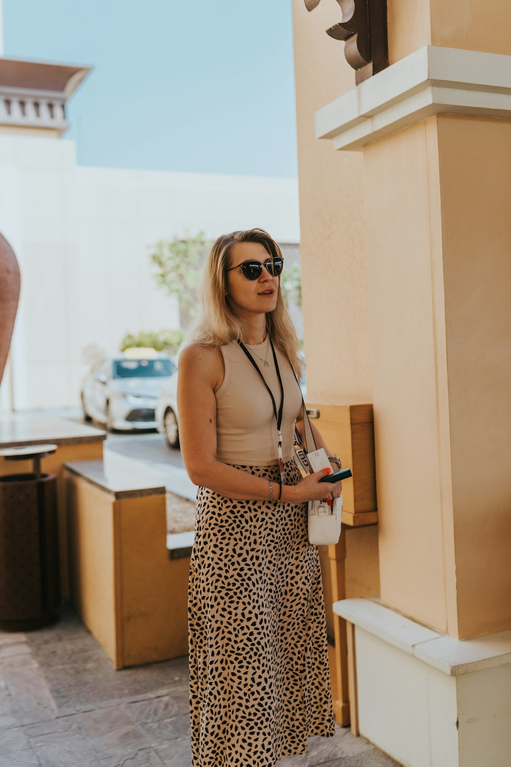 a woman wearing a leopard print skirt and sunglasses