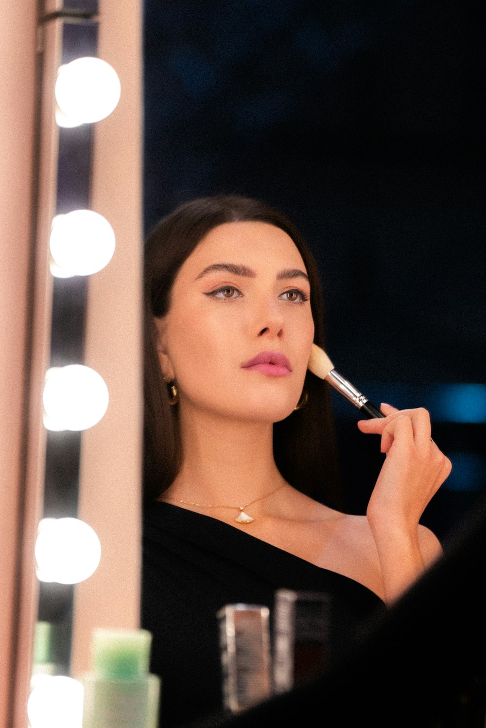 a woman is looking into a mirror while she brushes her teeth