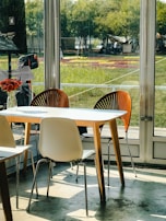 A family enjoying a bright room with wide windows framing a garden view.