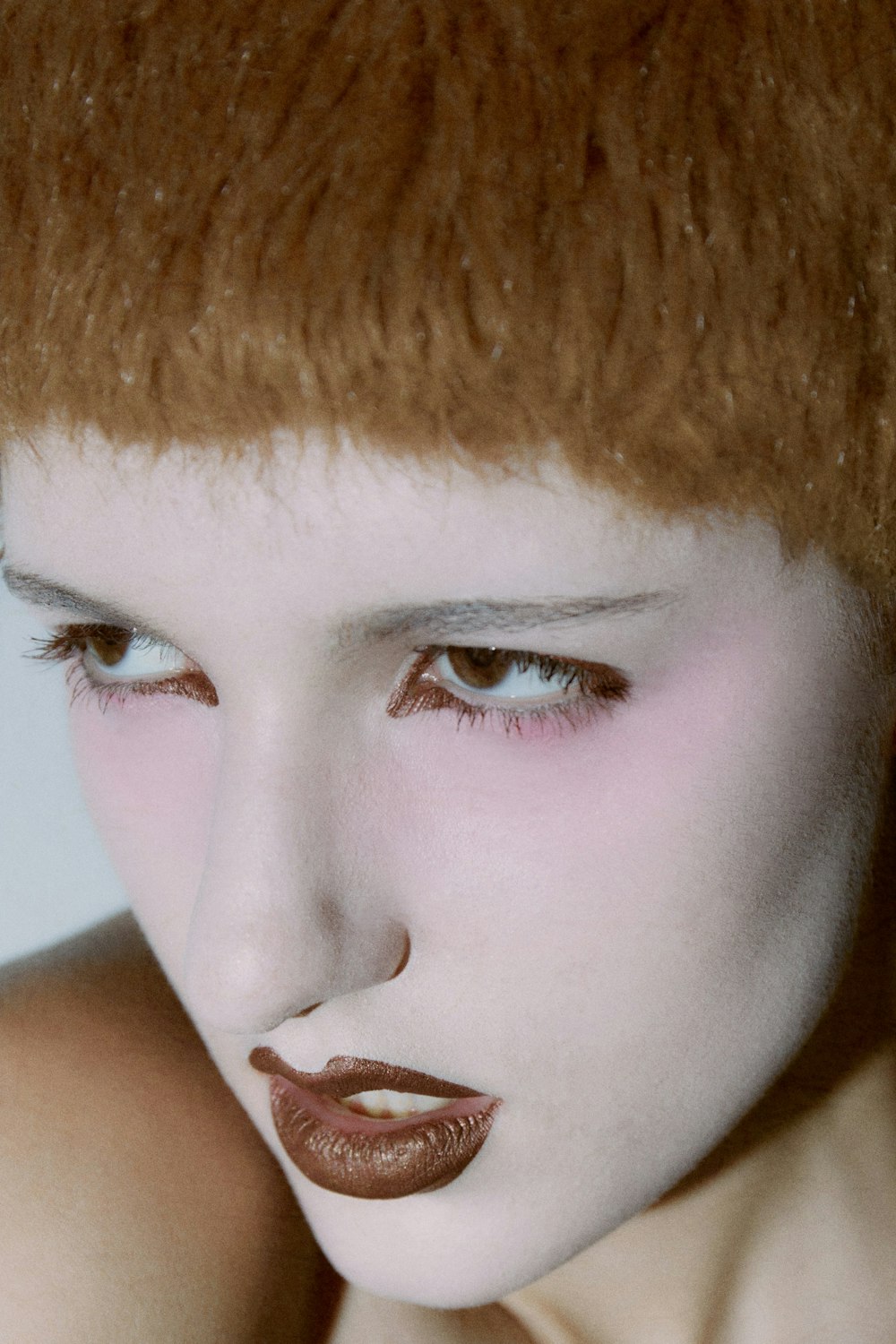 a close up of a woman with red hair