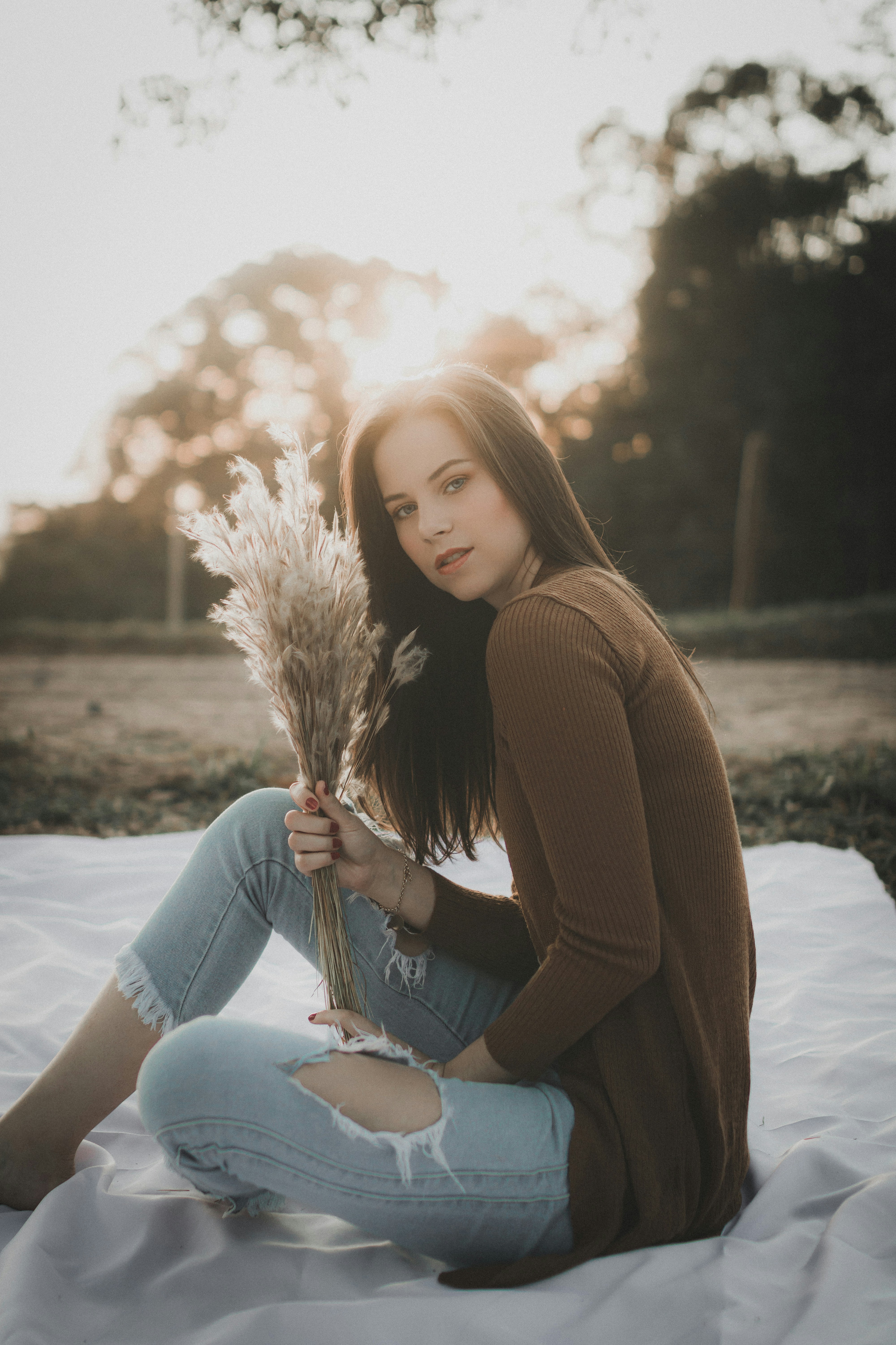 Senior model sitting in a field with flowers