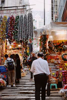 Vibrant market street bustling with colorful stalls and joyful travelers.