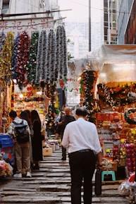 A festive market with holiday decorations and cheerful shoppers.