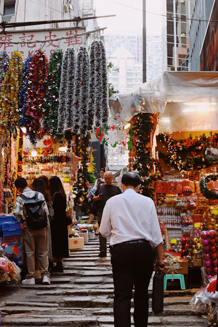 A vibrant market street bustling with colorful stalls and happy travelers.