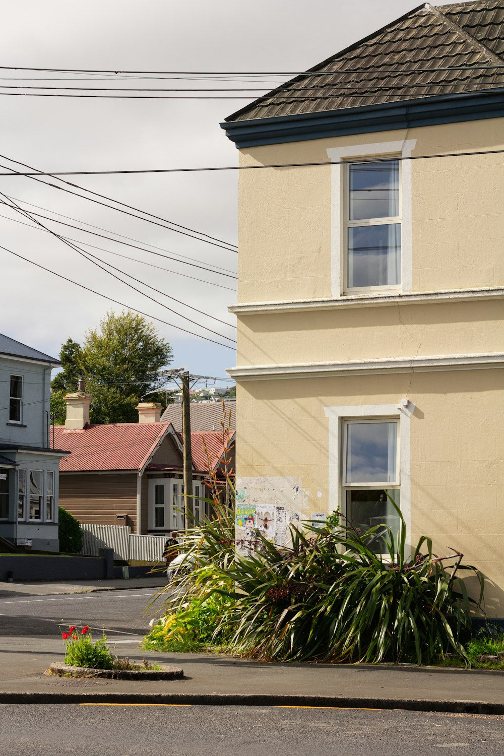 a street corner with a stop sign and a house