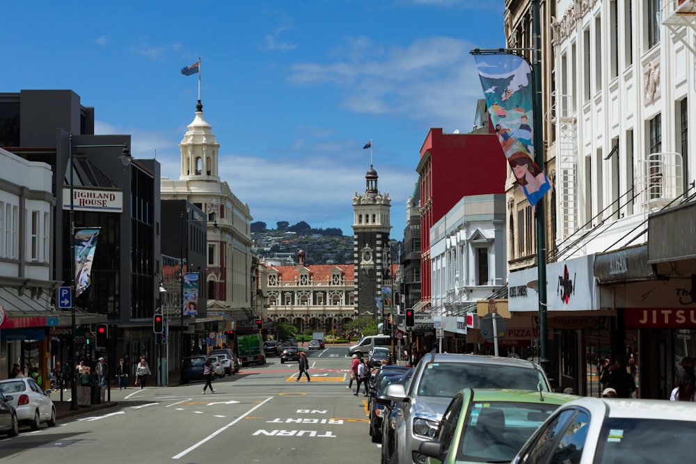 a city street lined with tall buildings and parked cars