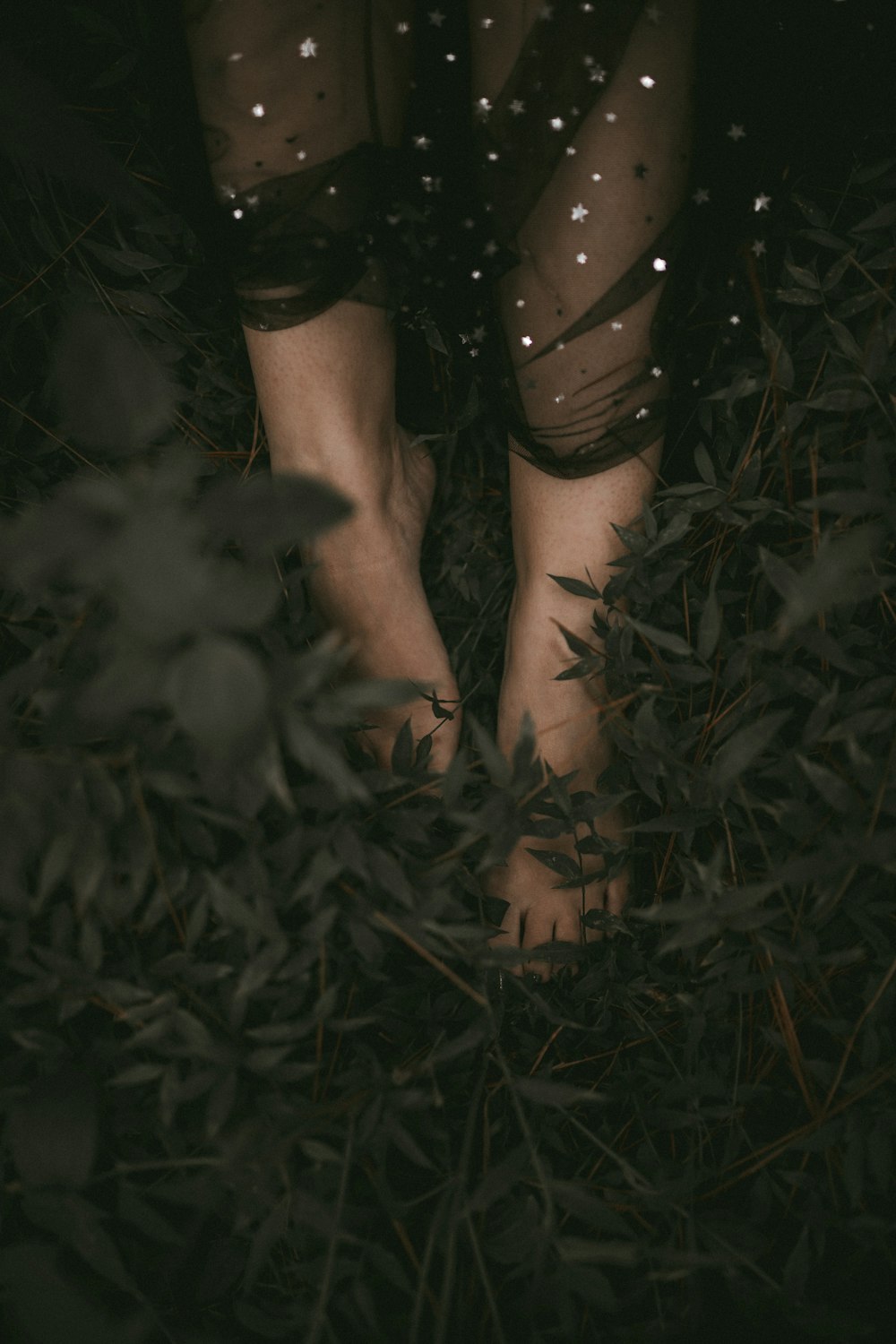 a woman's bare feet standing in the grass