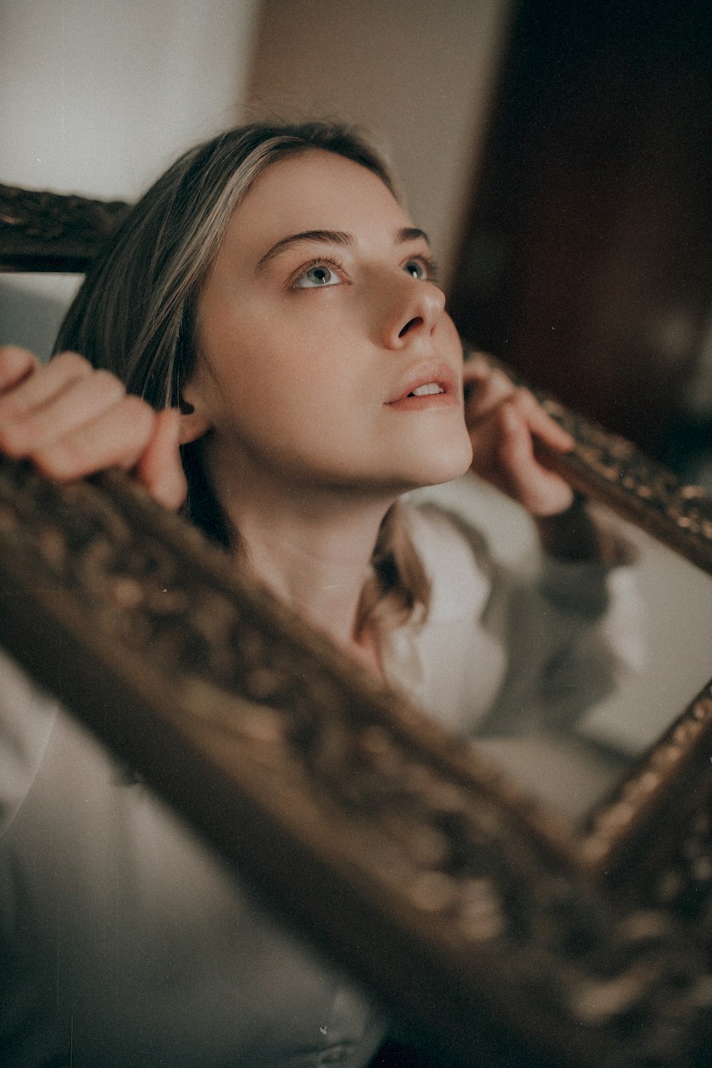 a woman looking at herself in a mirror