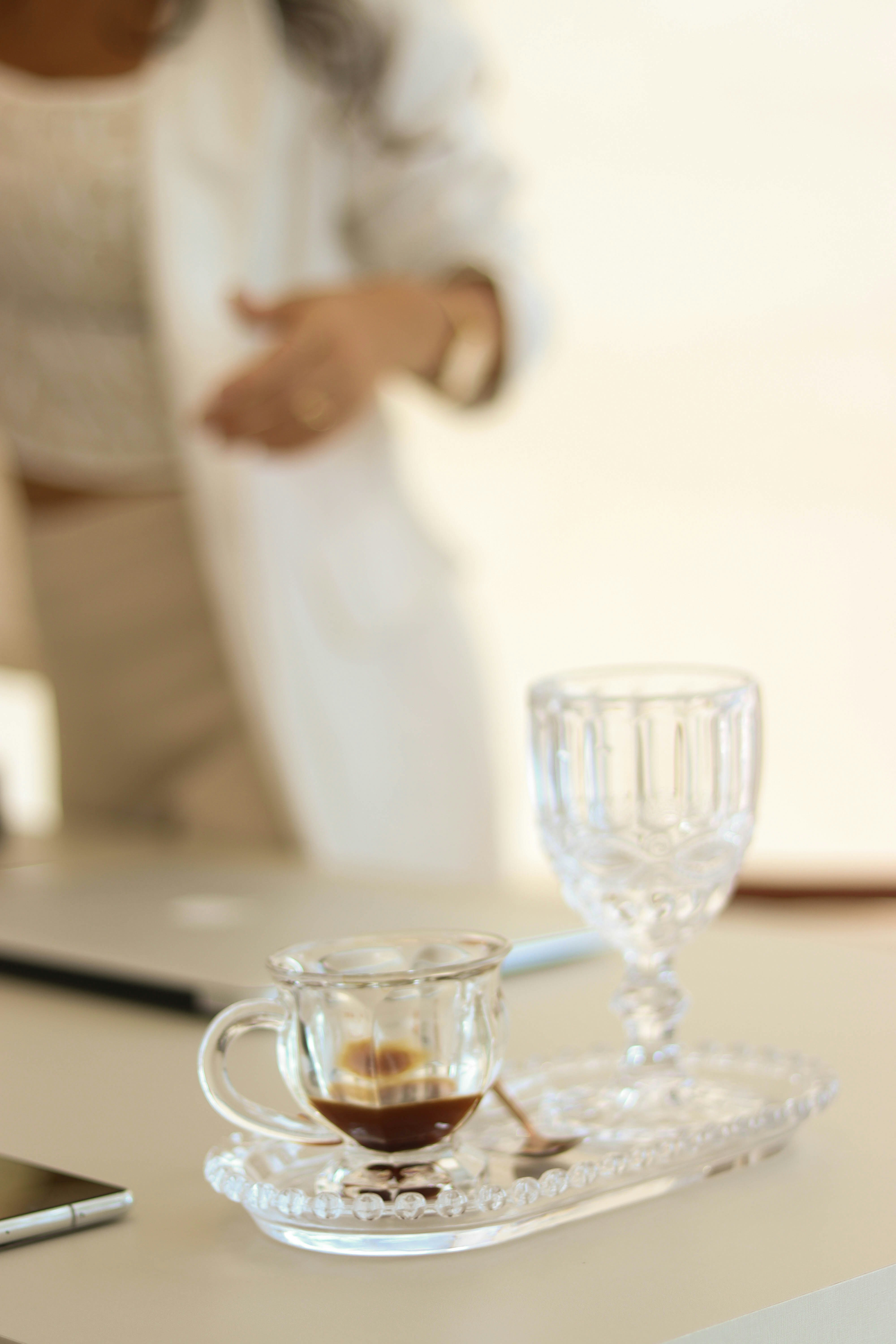 a cup of coffee sitting on top of a table