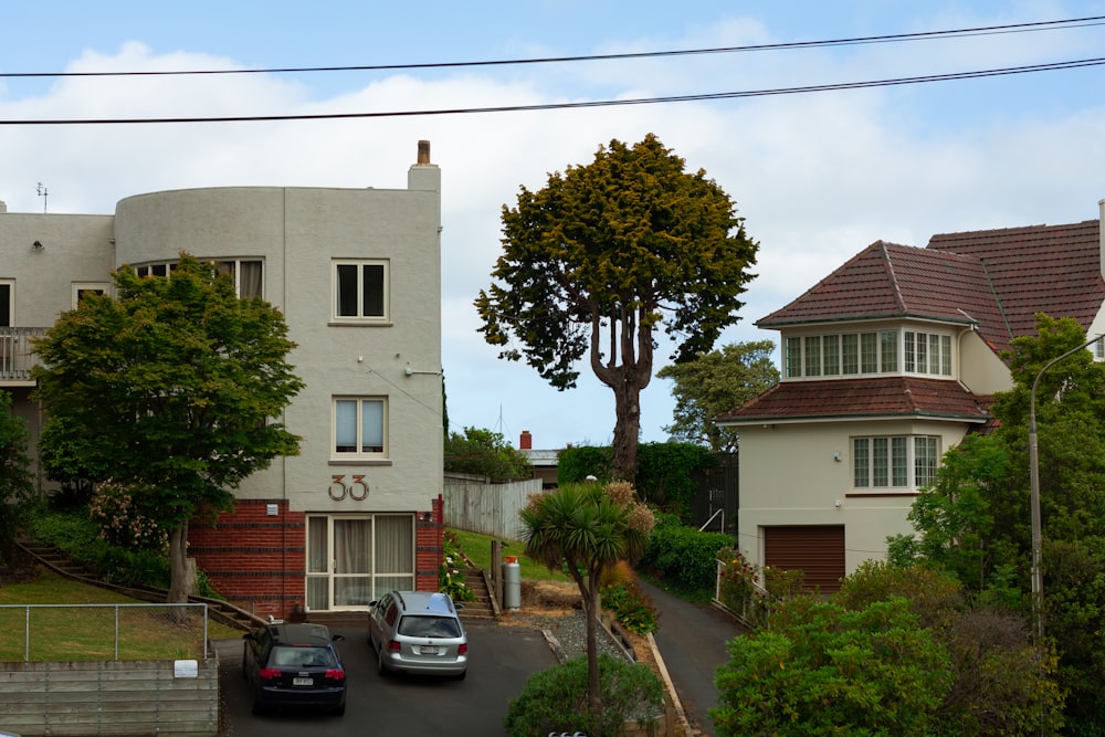 two cars are parked in front of a house