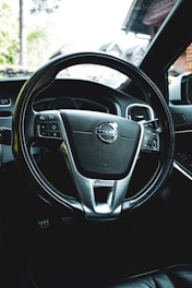 Close-up of a sleek steering wheel inside a modern training car.