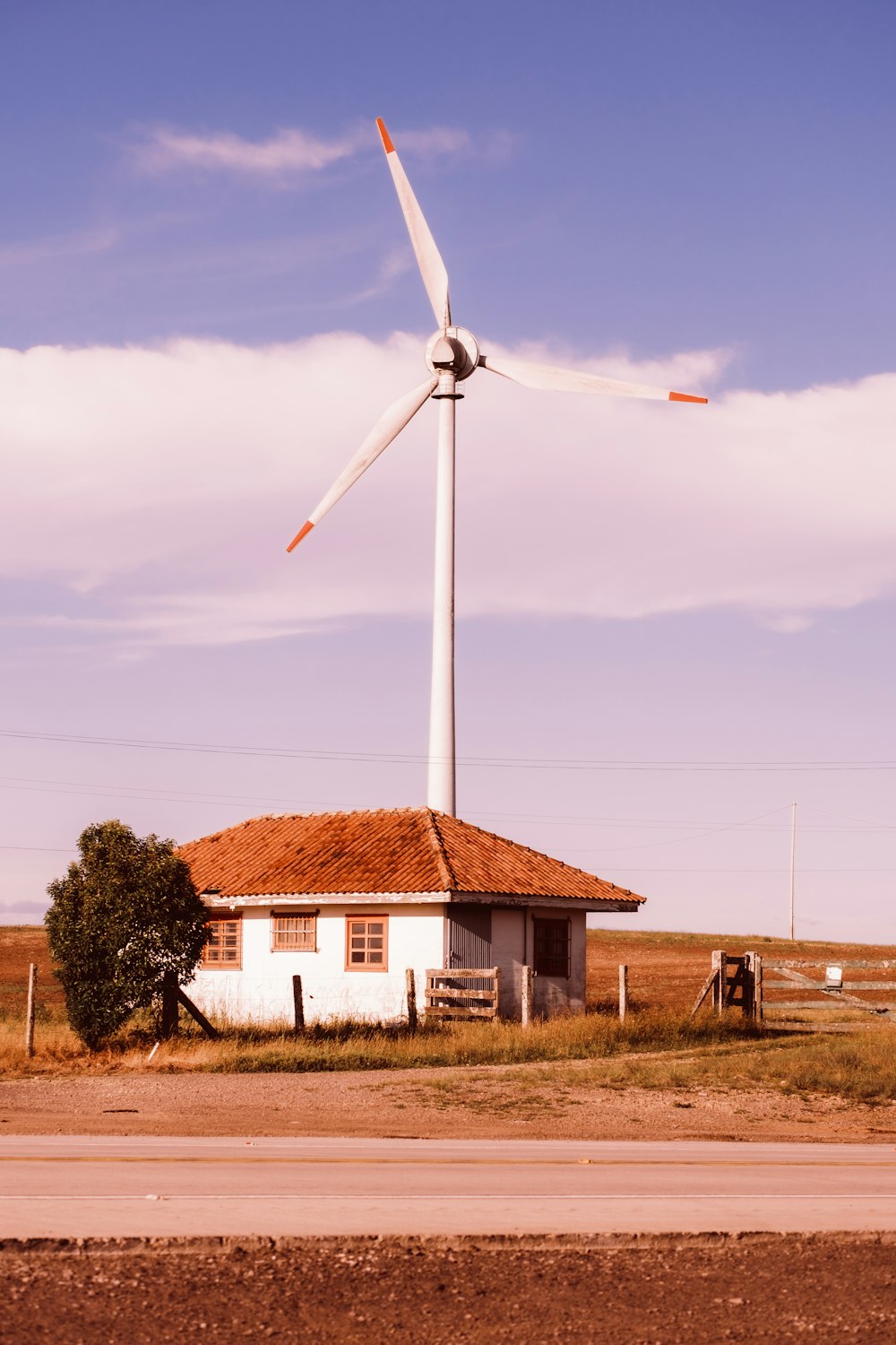 a house with a windmill in the background