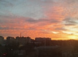 City skyline view from an office window during sunset.