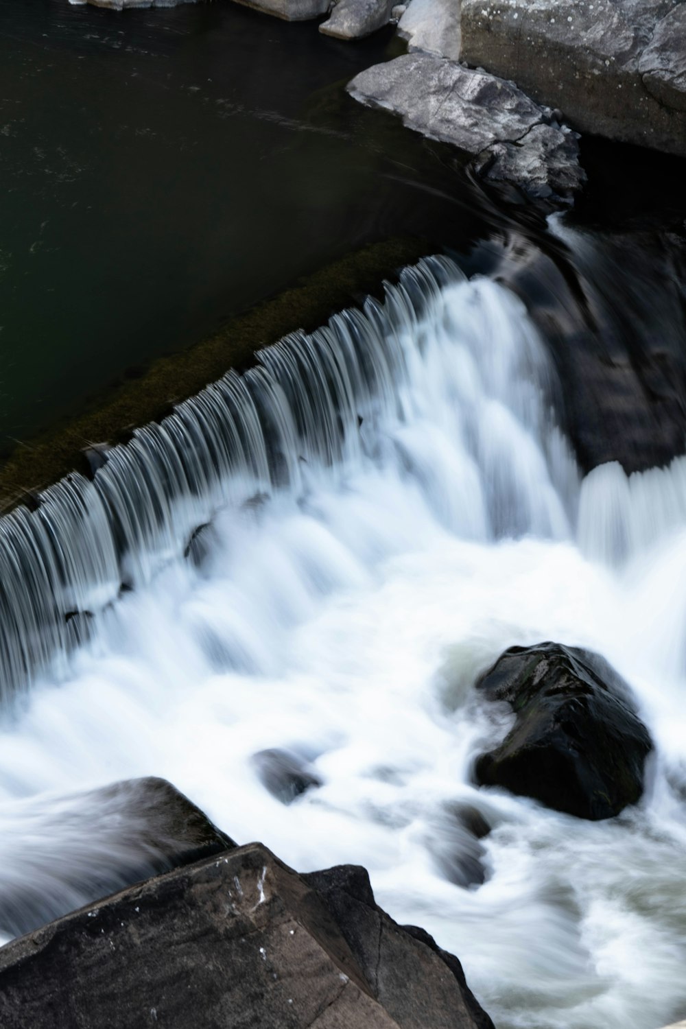 a small waterfall with water running over rocks