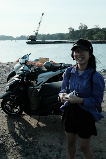 A local driver partner smiling warmly beside his scooter, ready for a day of tours.