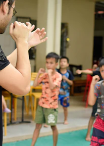 A group of diverse students practicing karate under expert guidance.