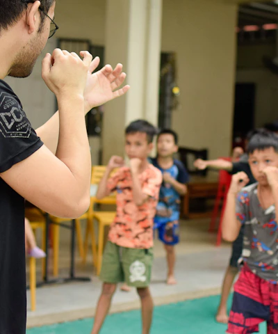 A group of diverse students practicing karate under expert guidance.
