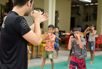 Instructor demonstrating self-defense techniques to students