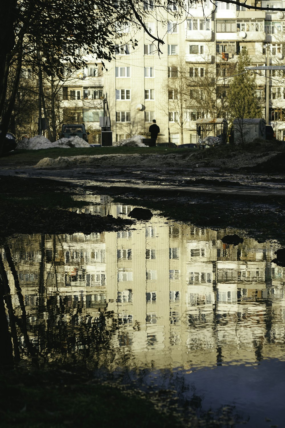 a reflection of a building in a body of water