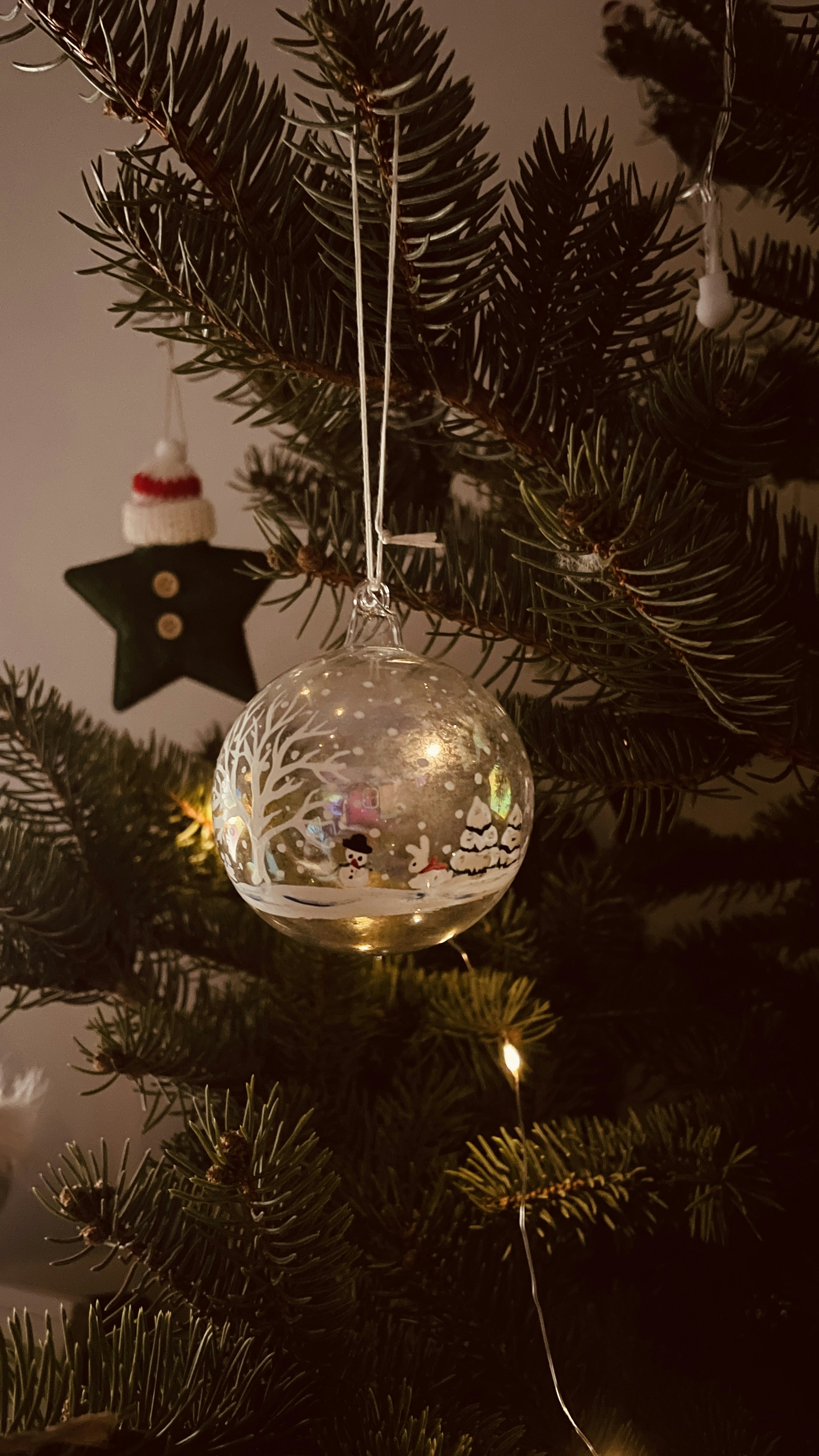 a christmas ornament hanging from a christmas tree
