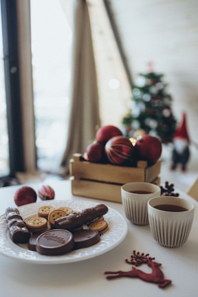 A cozy scene featuring a children's Christmas box surrounded by colorful snacks and playful decorations.