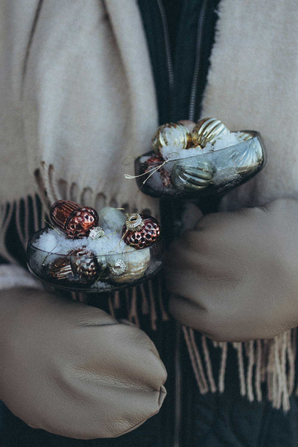 a close up of a person wearing a scarf and gloves