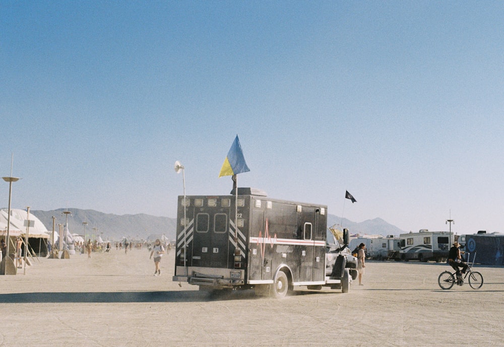 a man riding a bike next to a truck