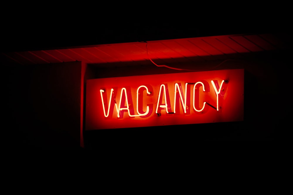 a red neon sign that says vacancy