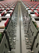 Close-up of telecom rectifiers and control panels neatly arranged on a workbench