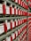 Rows of vintage electrical components with red handles and labels reading 'Cook Electric'. Each component has a label with letters and numbers.