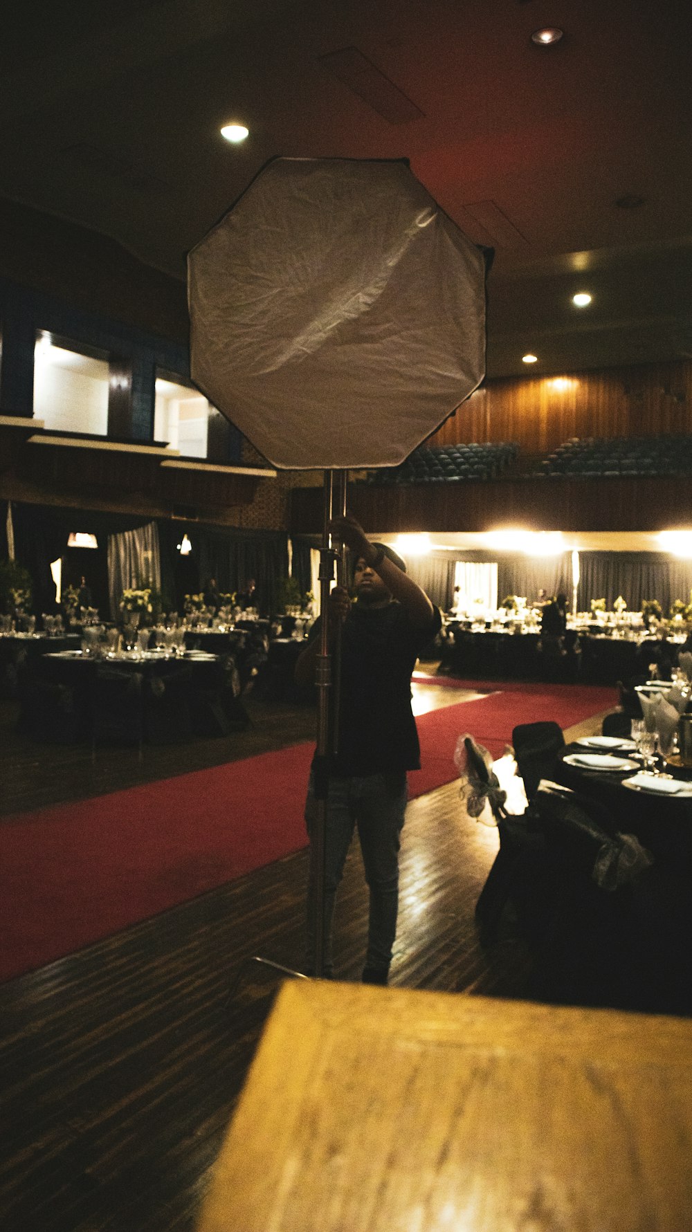 a person standing in a room with tables and chairs