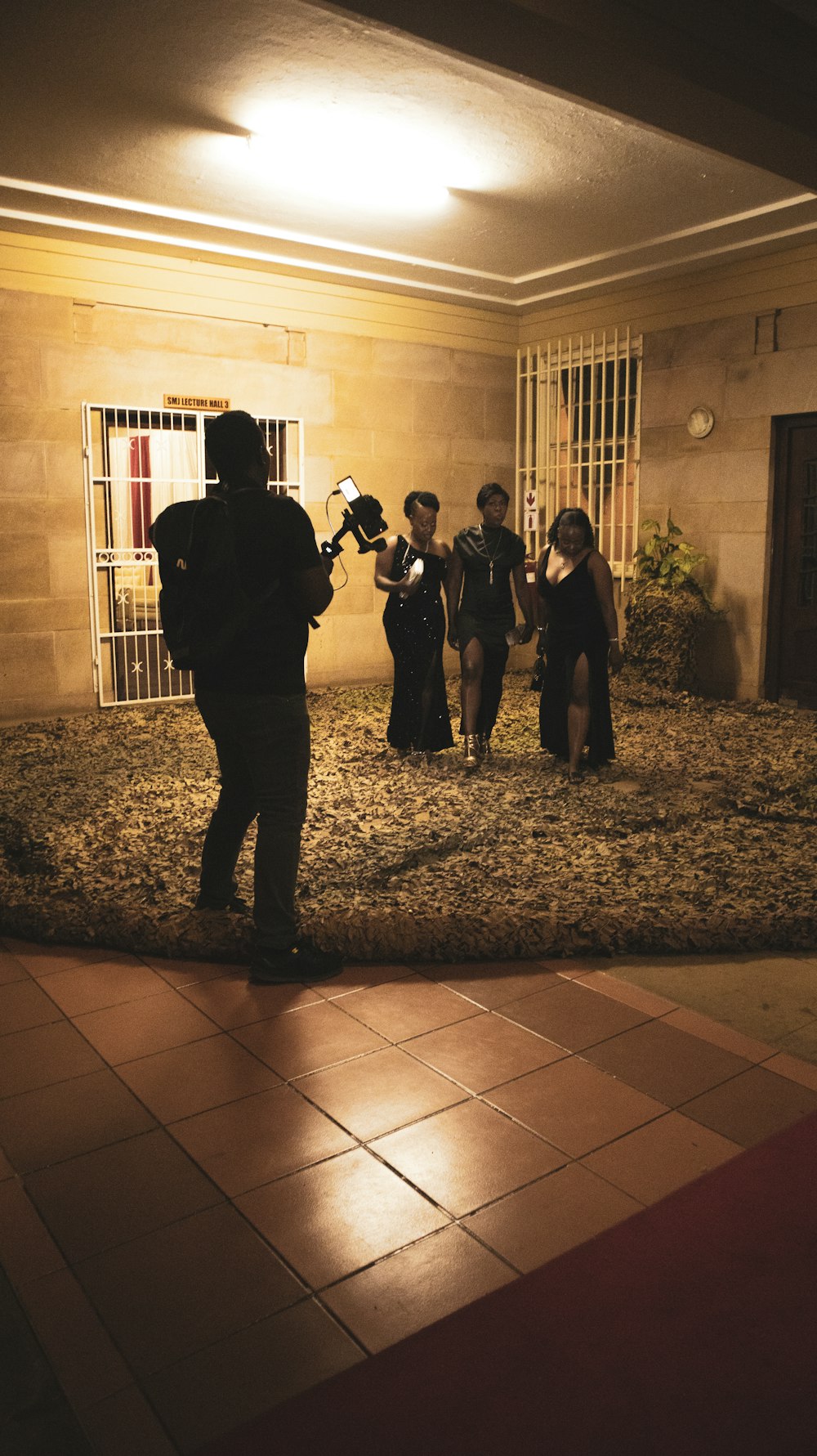 a group of people standing in a courtyard at night