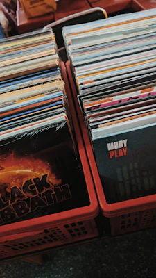 Stack of punk rock vinyl records with colorful, edgy album covers arranged neatly.