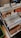 A collection of vinyl records organized in several rows, divided by labeled tabs indicating different music genres such as Rock, Jazz, and Funk, Soul. Visible album covers include artists like Ian Hunter and Stevie Wonder. The records are neatly arranged in a box with a wooden surface and some patterns partially visible on the left side.
