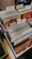 A collection of vinyl records organized in several rows, divided by labeled tabs indicating different music genres such as Rock, Jazz, and Funk, Soul. Visible album covers include artists like Ian Hunter and Stevie Wonder. The records are neatly arranged in a box with a wooden surface and some patterns partially visible on the left side.