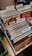 A collection of vinyl records organized in several rows, divided by labeled tabs indicating different music genres such as Rock, Jazz, and Funk, Soul. Visible album covers include artists like Ian Hunter and Stevie Wonder. The records are neatly arranged in a box with a wooden surface and some patterns partially visible on the left side.