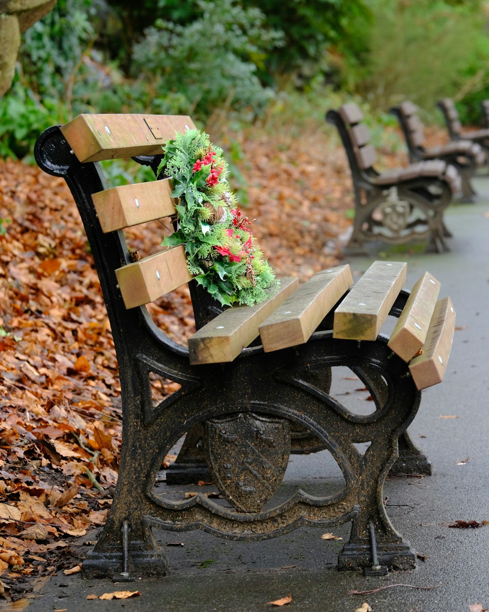 a park bench with a christmas wreath on it
