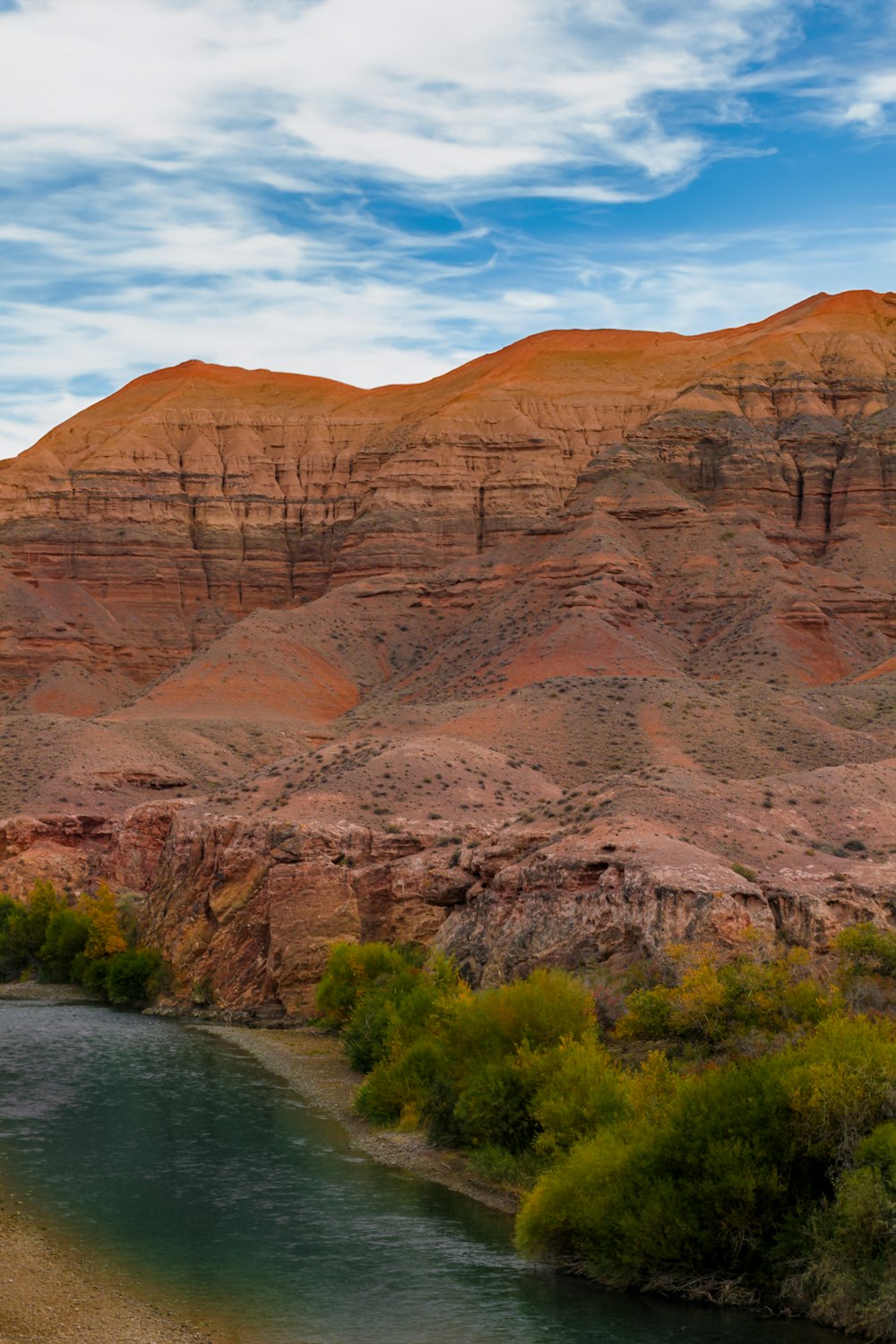 a body of water surrounded by mountains and trees