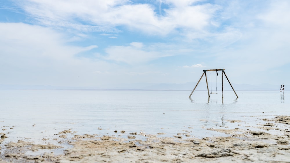 a swing set in the middle of a body of water