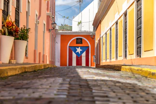 A warm, inviting community center entrance with colorful murals celebrating Puerto Rican culture.