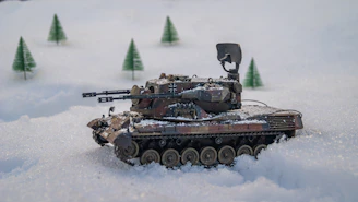 A scale model tank displayed on a diorama battlefield.