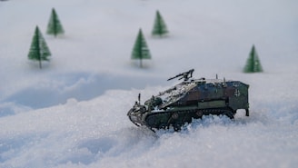 a tank in the snow with trees in the background, defense